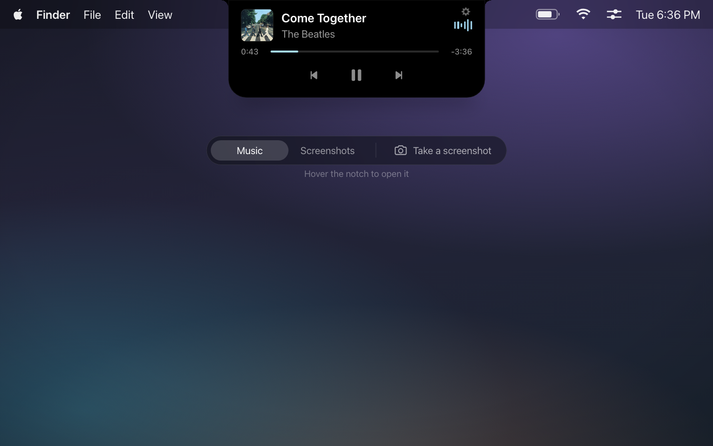 A macOS desktop with the notch expanded into a music panel: album art, track title, a progress scrubber and transport controls